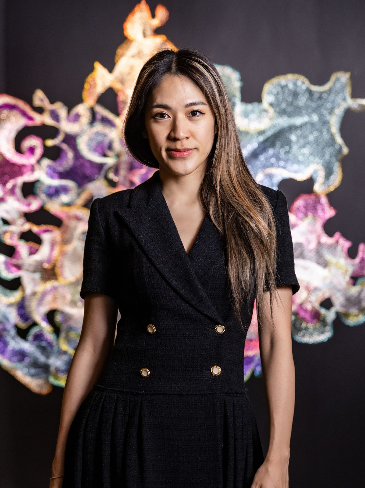 Portrait of Julia Hung in front of one of her works.